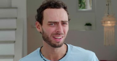 Close-up portrait of a mysterious Caucasian man looking around in bewilderment, denying, expressing misunderstanding
