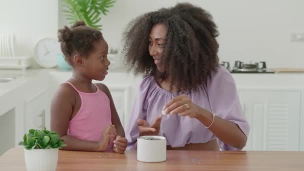 Loving Mother Teaching Little Daughter Kid Money Putting Coin Pink — Stockvideo