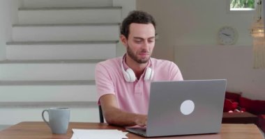 Inspired journalist, writing a grandiose article for newspaper while working remotely on a laptop, in a cozy home office