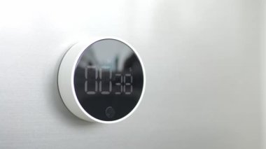 Minimalist kronometreye yakın plan, ters zaman tepkimesi ile, kopyalama alanı olan beyaz duvarda. Akış zamanı konsepti