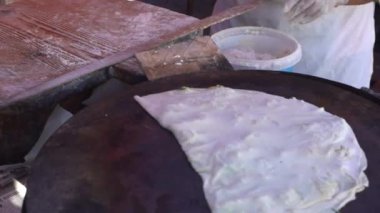 Alanya, Türkiye - 10 06 2021: Kadın, çiftçi pazarını dolduran geleneksel Türk ekmeği (gözleme) yapıyor. Sadece eller çerçevede. 4 bin. Belgesel. 