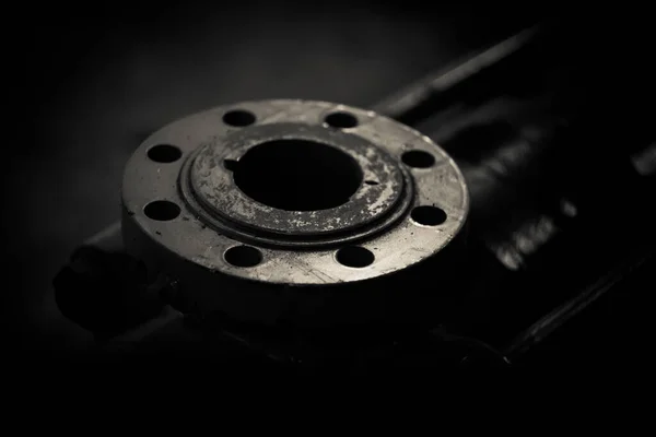 Big metal shaft and rotor close up. A part of big industrial motor on a dark background