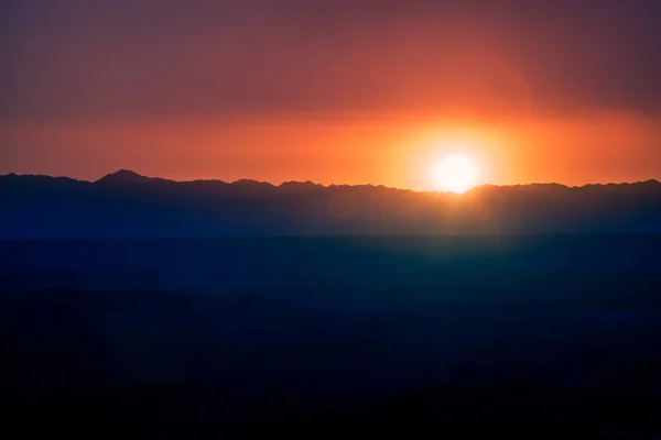 Sunset over the mountain ridge in summer. 