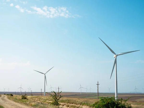 zero carbon emissions and renewable energy sources. Panoramic view of wind farm or wind park, with high wind turbines for generation green electricity