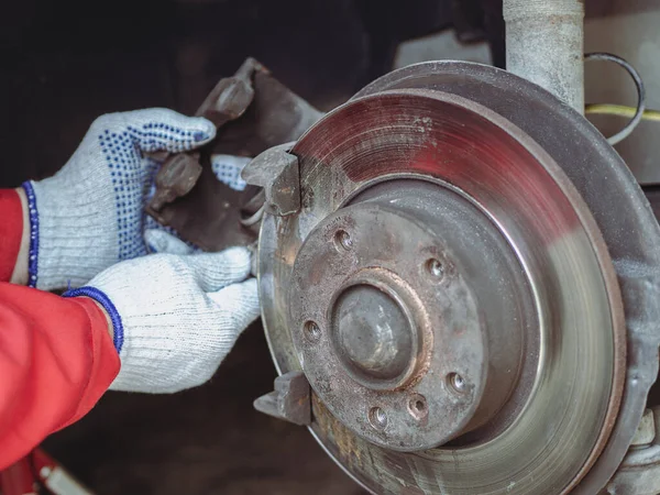 Male mechanic hands removing brake caliper. Maintenance of Car brakes. Car Maintenance tips.