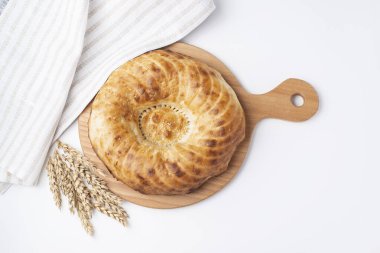 Tahtada ekmek, havlu, arka planda mısır.