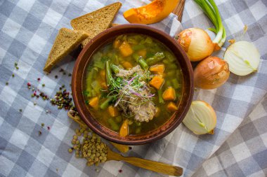 Masa örtüsünün üzerinde gerçek beslenme balkabağı çorbası. Üst görünüm