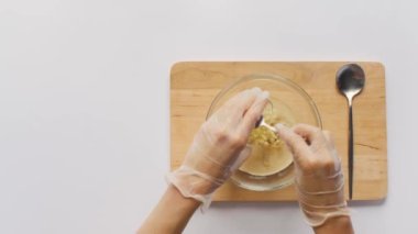 The chef puts raw marinated chicken fillet in a pot with vegetables. The concept of cooking organic chicken in the oven