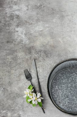 Place table setting with blossoming apple tree branches and flowers