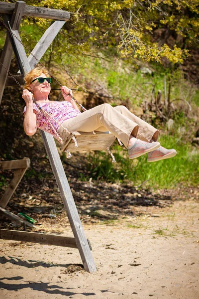 Senior Woman Joyfully Swinging Swing Having Fan Happy Retirement Concept — 스톡 사진