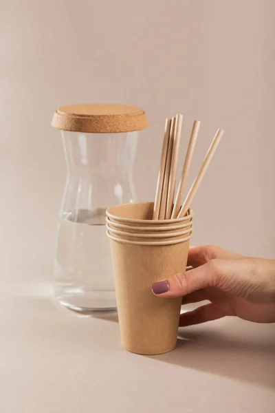 Disposable tableware from natural materials. Biodegradable and compostable paper cup, straws