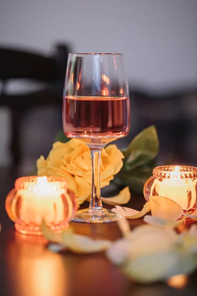 Glass Rose Wine Two Candles Rose Petals Dark Table Nice — стоковое фото