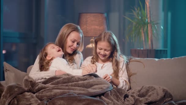 Irmãs com mãe desenhando no álbum enquanto descansam no sofá — Vídeo de Stock