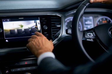Close up of man touching multimedia screen of car dashboard