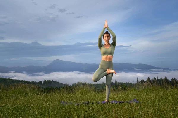 Bella donna che fa yoga all'aperto in montagna. — Foto Stock