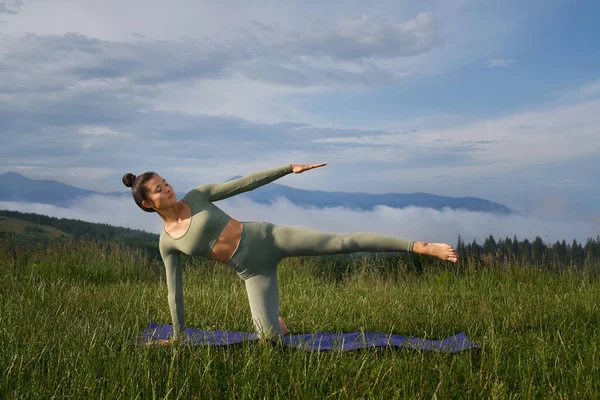 Fitness woman in sport clothes exercising on fresh air