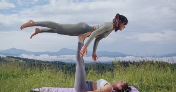 Duas mulheres fazendo equilíbrio acro ioga ao ar livre — Vídeo de Stock