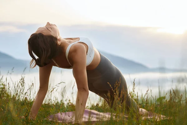 Girl practicing yoga position in mountains. — Foto Stock