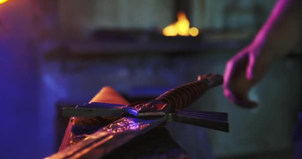 Blacksmith forging big sword in workshop. — Stock video