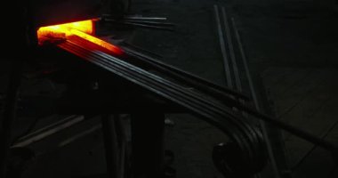 Black stick with hook in furnplace forging.
