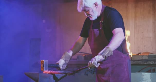Blacksmith exhausted from difficult manual work. — Stock video