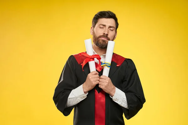 Bachelor, master standing, holding two diplomas. — Stockfoto