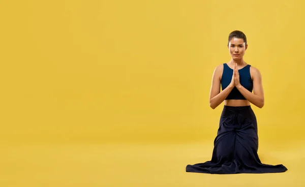 Yoga instructor in prayer pose, exercising in studio. — Stock Fotó