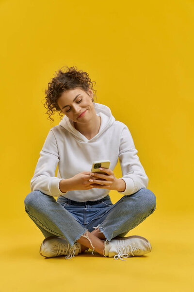 Smiling Teen Surfing Internet Smartphone While Sitting Floor Front View Stock Image