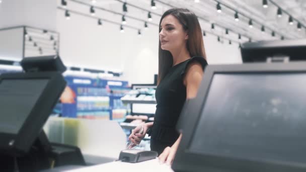 Giovane donna fare due chiacchiere con il venditore mentre paga in negozio di cosmetici. — Video Stock