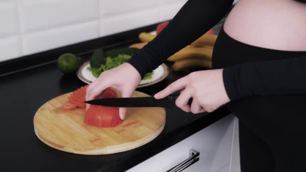 Gravid kvinna skivning tomater för veggie sallad — Stockvideo