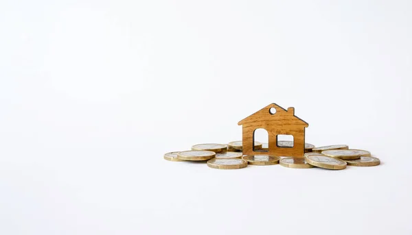 Pile Coins Wooden Figurine House Light Background Concept Investment Construction — Zdjęcie stockowe