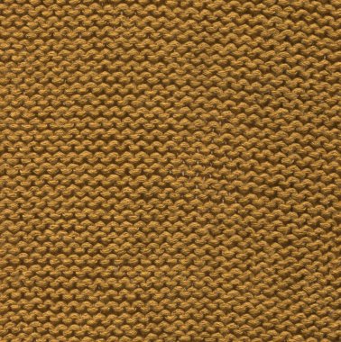 Merino mustard wool knit texture for the design. Knitted woolen cotton fabric background in mustard  color.
