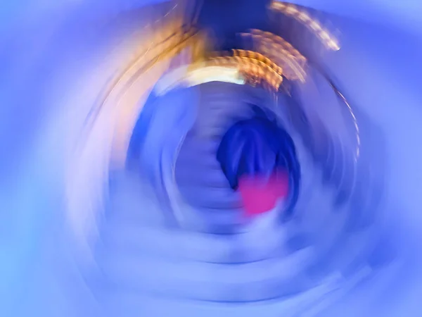 Long concrete tunnel with people out of focus background. Blurred motion background of underground passage and people.