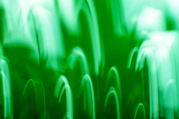 Zoomed abstract green background with radial radiating lines. Abstract green image of  light zoom trails.