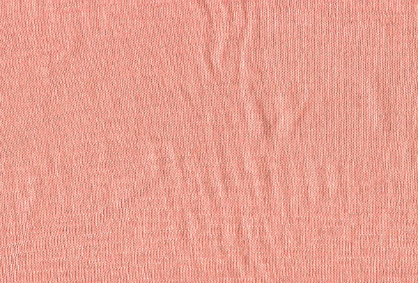 Texture of a knitted pink sweater wallpaper. Textile pink material with wicker pattern.