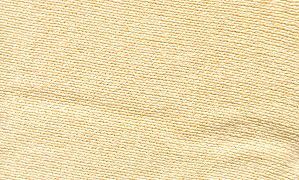 Abstract beige soft knitted pattern textured. Beige  knitted boho fabric texture with blank space for ads.