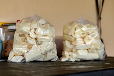 Plastic bags with pieces of peeled and washed cassava