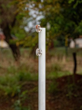 Voleybol sahasında ağı genişletmek için metal bir direğin üzerinde makara.