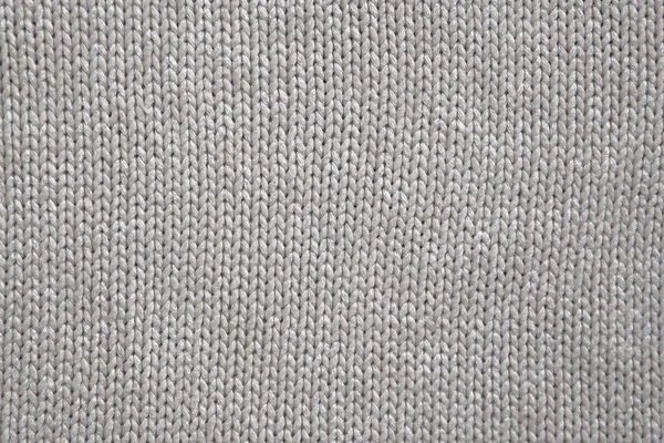 Background of knitted texture of fabric of pale color or knitwear closeup — Stock Photo, Image