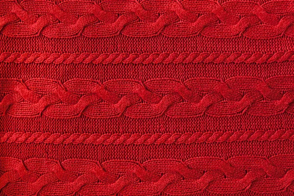Stickad ull bakgrund, röd textur. Stickat tyg. — Stockfoto