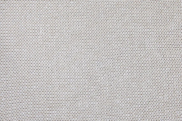 Background of knitted texture of fabric of pale color or knitwear closeup — Stock Photo, Image