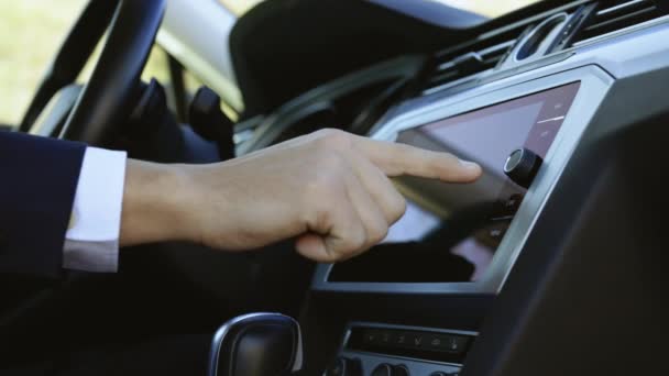 Hombre de negocios irreconocible en traje mano tocando, haciendo clic, tocando, deslizando, arrastrando y deslizando en el monitor de pantalla en el coche de lujo moderno. Concepto de interfaz — Vídeo de stock