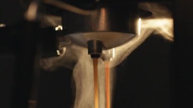 Drinking roasted black coffee in the morning. Making double espresso. Flowing fresh ground coffee. Pouring coffee stream from professional machine in cup. Hot Coffee Drink Concept
