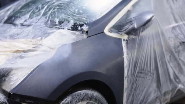 Fábrica de automóviles Cuerpo de coche de color negro. Trabajadores industriales en, fábrica de automóviles, planta de producción de automóviles. Prepara la carrocería para pintar. Ala de coche negro. — Vídeo de stock