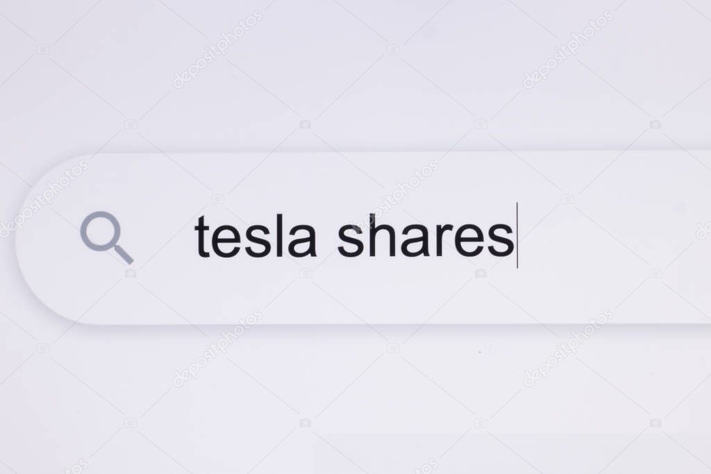 Typing the word Tesla shares in the browser on a pixelated screen. Searching For an Online Network Website. Searching The World Wide Web Internet on a Computer