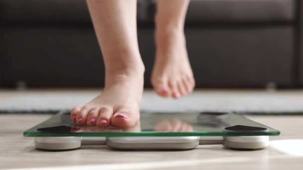 Woman On Scales Measure Weight. Girl Legs Step Bathroom Scale. Fitness Diet Woman Feet Standing Weighing Scales On Room. Barefoot Measuring Body Fat Overweight. Female Dieting Checking BMI Weight Loss — Video Stock