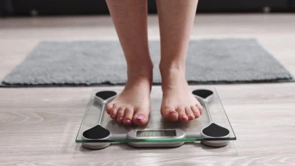 Female On Scales Measure Weight. Fit Girl Legs Step Bathroom Scale. Fitness Diet Woman Feet Standing Weighing Scales. Barefoot Measuring Body Fat Overweight. Dieting Woman Checking BMI Weight Loss. — Vídeo de stock