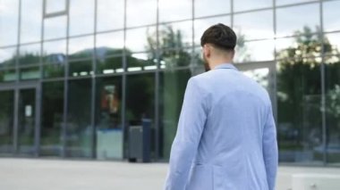 Young caucasian businessman on hurry walking on stairs look at watch running city male stairway step suit time job smart concept young slow motion. Man Scrolling On Display On Smartwatch Notification.