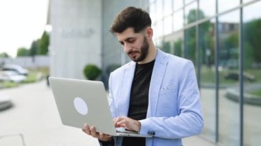 Handsome bearded businessman professional financial advisor, executive leader, manager, male lawyer or man entrepreneur standing near office posing for headshot business portrait.