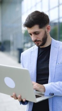 Vertical video of handsome bearded businessman professional financial advisor, executive leader, manager, male lawyer or man entrepreneur standing in office posing for headshot business portrait.